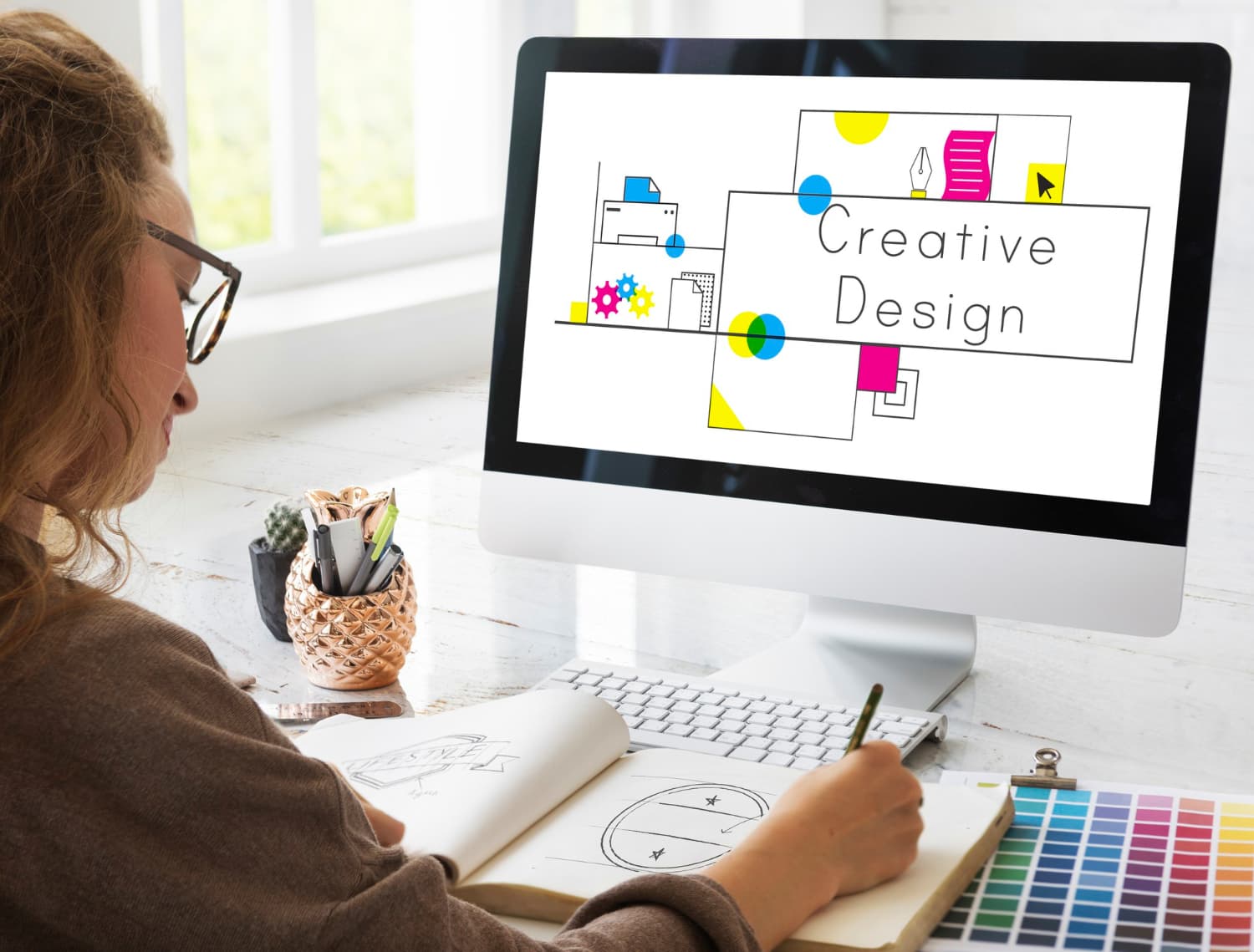 Designer reviewing a user flow on a desktop display